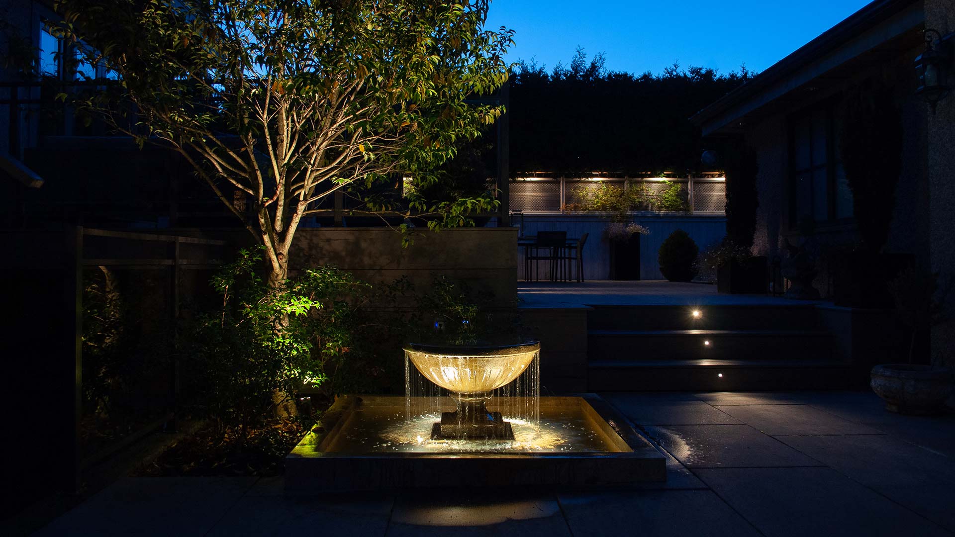 Landscape lighting and water feature in Marpole garden terrace from landscape design project