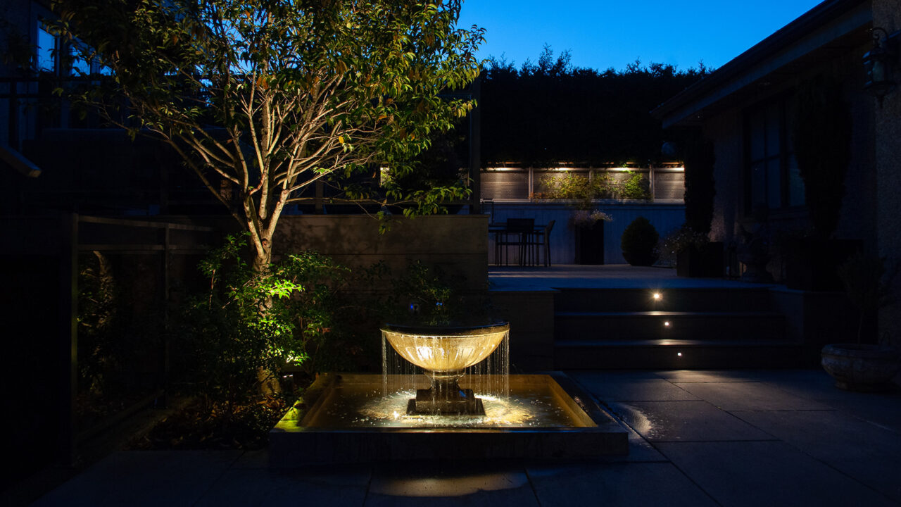Backyard design with outdoor lighting in Vancouver
