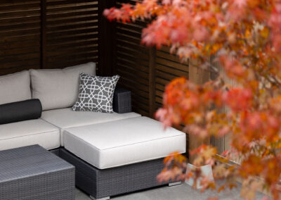 Modern backyard design with outdoor seating area and privacy screening