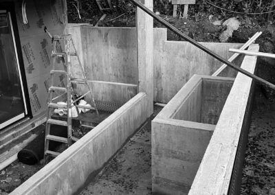 concrete walls to be clad with stone, raised planting beds in landscape