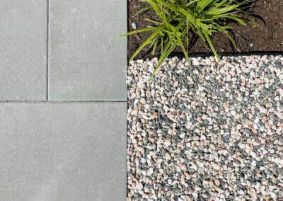 Decorative gravel, concrete paving and ornamental grasses in East Vancouver by 161 Design Studio.