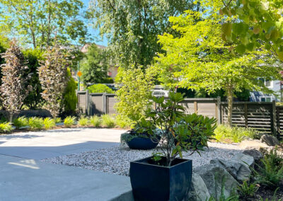 Landscape design detail in East Vancouver — concrete entry steps, decorative gravel, and container planting by 161 Design Studio.